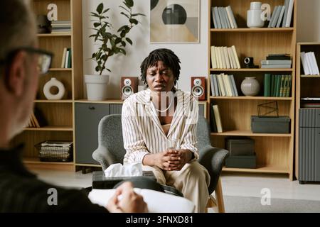 Black Woman Talking during Psychotherapy Session in Office Stock Photo