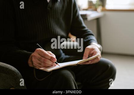 Therapist Taking Notes during Psychology Session in Office Stock Photo