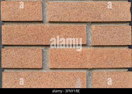 Rough red brick wall surface creating a repeating pattern, showcasing the texture of old weathered brickwork and mortar, ideal for construction or arc Stock Photo