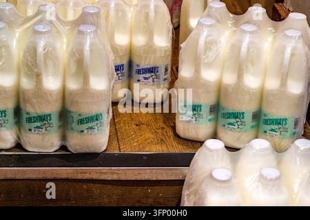 London, UK, October 05 2026, Branded Milk In Plastic Bottles Back-Of-House Storage Room High Street Coffee Shop Stock Photo
