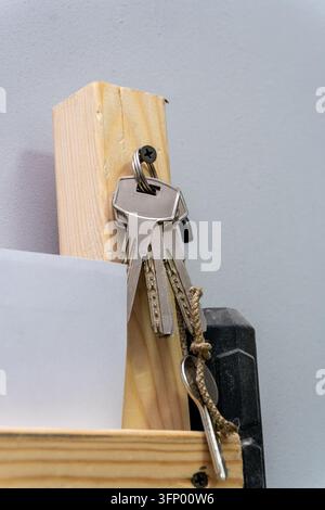 Set of keys hanging on wooden block in workshop Stock Photo