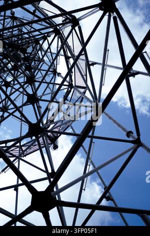 Industrial metal framework forming a geodesic pattern reaching towards the sky Stock Photo
