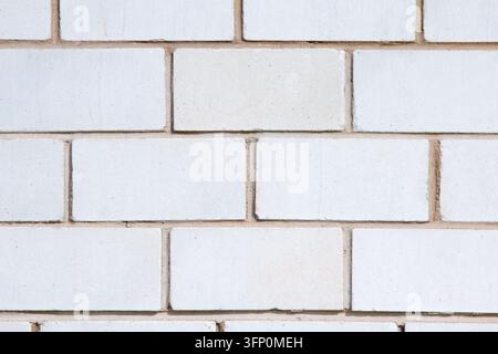 White brick wall texture background. Close-up of light silicate brickwork with mortar joints. Clean architectural or construction background. Stock Photo