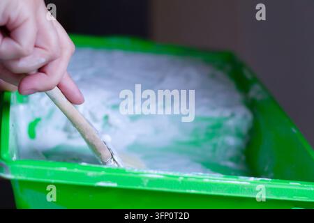 Close-up of the process of preparing paint, primer, or plaster before application. A DIY repair and home improvement concept. Stock Photo