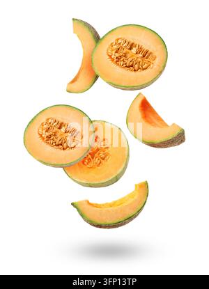 Pieces of cantaloupe melon falling on white background Stock Photo