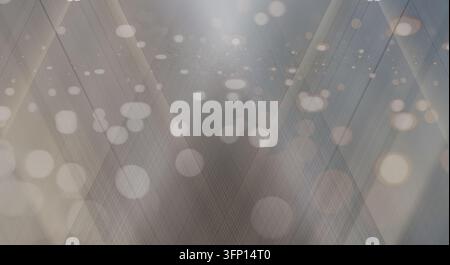 An abstract background featuring silver and gray tones with intersecting light beams and soft bokeh circles. Stock Photo