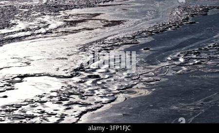 Intricate patterns of crystalline river ice illuminated by golden ...