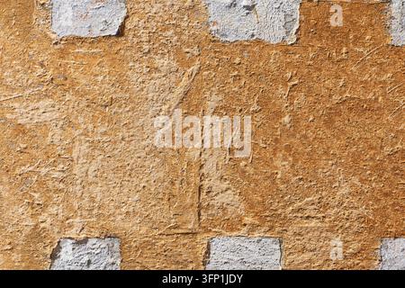 Texture of an old medieval wall, orange-ochre, with old stones Stock Photo