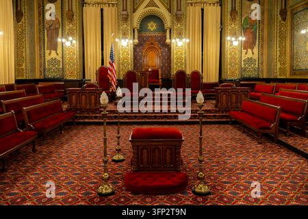 Philadelphia, Pennsylvania - August 29, 2026: Symmetrical wide perspective of Norman Hall lodge room showing red velvet officer benches, altar, and St Stock Photo