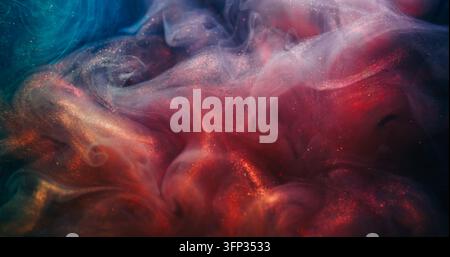 Swirling fluid. Paint background. Defocused orange blue neon color splash glitter liquid texture spreading on acrylic art abstraction. Stock Photo