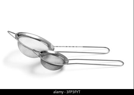 Food preparation and cooking, two stainless steel kitchen strainers for baking and culinary tasks isolated on a clean white background Stock Photo