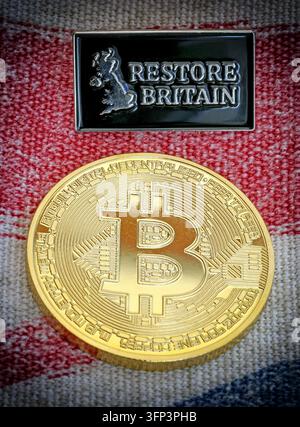 Restore Britain political memorabilia and a gold Bitcoin souvenir shown together in a staged still life. Stock Photo