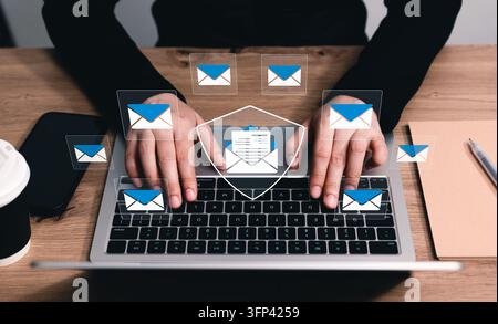Email security and spam protection concept. Person using laptop with digital shield envelope icons, anti phishing firewall, safe electronic mail inbox Stock Photo