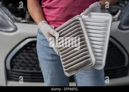 Filte Image A woman compares old and new cabin air filters Stock Photo - Alamy