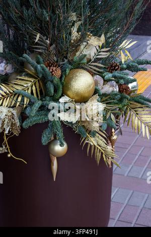 A Christmas bouquet of golden balls and branches in a large vase Stock Photo