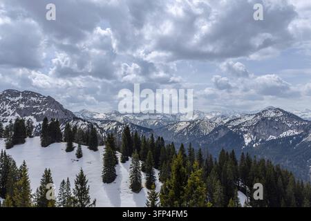 Bavarian Alps. A peaceful winter scene of serene snow-covered wilderness with majestic mountains and a dense pine forest Stock Photo