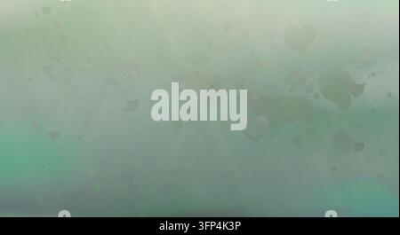 Soft mint green and pastel gradient background adorned with faded heart shapes, light spots, and floating dust particles. Stock Photo
