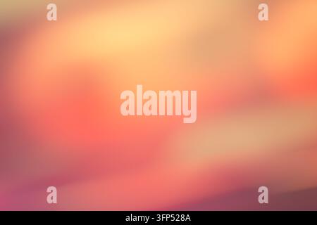 Abstract warm orange and pink blurred background with soft light gradient.  Soft focus bokeh abstract background in pastel orange and violet tones Stock Photo
