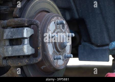 Detailed view of a worn automotive braking system component showing corrosion and wear on the metal parts Stock Photo