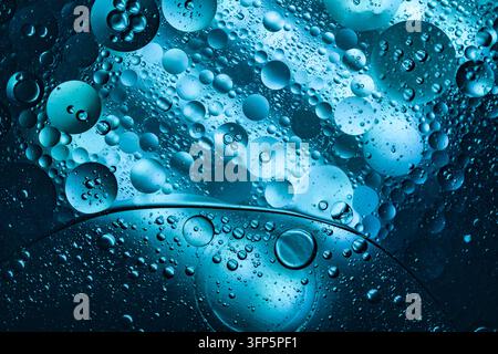 Abstract macro background of blue oil droplets on water surface, liquid sphere texture for biotech and cosmetic concept Stock Photo