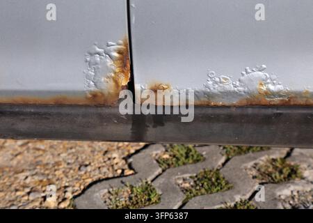 Rusting door in an old car. Weather damage in vehicle. Stock Photo