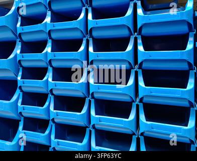 Stacked blue plastic boxes for sale in a hardware store Stock Photo