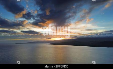 Aerial view of breathtaking sunset over tranquil ocean waters with vibrant colors illuminating the sky Stock Photo