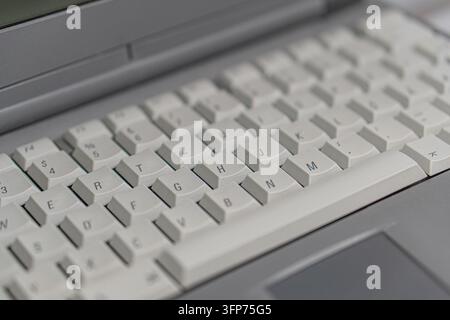 Close-up view of a well-lit laptop keyboard, QWERTY layout, white keys with black lettering, evenly spaced, space bar key larger, no screen text, prac Stock Photo