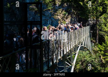 Bavaria, Germany, 06 September 2026 A large crowd of tourists waits packed on the famous Marienbruecke (Mary Bridge) footbridge overlooking the Pollat Stock Photo