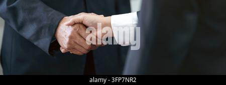 Lawyer consultant shaking hand with client in law firm Stock Photo