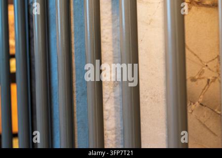 Close up view of vertical metal display bars over polished marble tiles Stock Photo