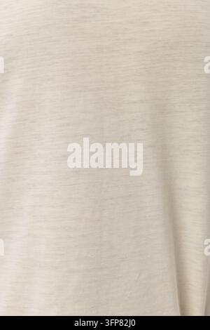 Close-up macro texture of soft cream beige knit fabric. Detailed view of natural cotton heathered textile background. Perfect for clothing, fashion, a Stock Photo