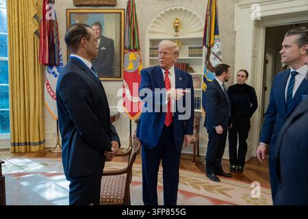 Washington, United States of America. 20 February, 2025. U.S. President Donald Trump speaks with golfer Tiger Woods and officials in the Oval Office of the White House, February 20, 2025 in Washington, D.C. Woods, who received the Presidential Medal of Freedom from Trump in 2019, joined PGA Tour leaders at the White House for talks on a proposed deal with Saudi Arabia’s Public Investment Fund before Trump introduced him as a surprise guest at a Black History Month reception.Credit: Joyce N. Boghosian/White House Photo/Alamy Live News Stock Photo