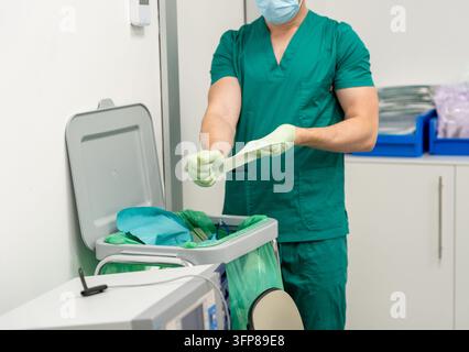 Healthcare professional putting on sterile gloves for surgery or patient examination Stock Photo