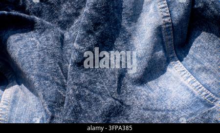 Wrinkled Blue Denim Jeans Texture With Visible Seams Stock Photo