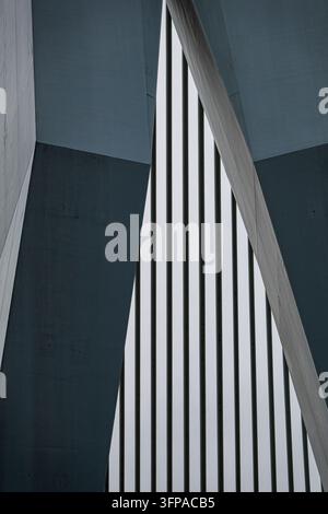 View of abstract modern architectural details featuring sharp concrete angles and vertical metal slats in Rotterdam, South Holland, Netherlands. Stock Photo
