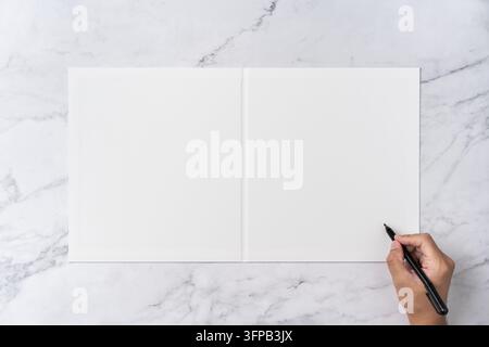 Top view sequence from open to close blank white greeting card mockup on marble background with copy space : hand writing with black pen on opened bla Stock Photo