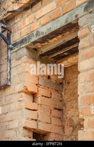 Close-up view of a brick wall construction showing a reinforced opening with a steel lintel and supporting bracket Stock Photo