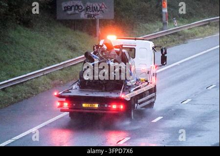M5 Motorway, Quinton, Birmingham 7th October 2026 - West Midlands Police and Fire Service on scene of a fatal collision on the Northbound M5 Motorway between Junctions 4 and 3 close to the Quinton area of Birmingham on Tuesday (6th) evening. A 39-year-old man, who was driving a silver Peugeot died of fatal injuries at the scene after his vehicle ploughed into the rear of a lorry and caught fire. The car was  pictured on the back of a recovery vehicle with the front completely crumpled. The side of the trailer was also pictured with a large section melted by the fire that ensued after the colli Stock Photo