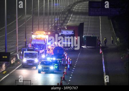 M5 Motorway, Quinton, Birmingham 7th October 2026 - West Midlands Police and Fire Service on scene of a fatal collision on the Northbound M5 Motorway between Junctions 4 and 3 close to the Quinton area of Birmingham on Tuesday (6th) evening. A 39-year-old man, who was driving a silver Peugeot died of fatal injuries at the scene after his vehicle ploughed into the rear of a lorry and caught fire. The car was  pictured on the back of a recovery vehicle with the front completely crumpled. The side of the trailer was also pictured with a large section melted by the fire that ensued after the colli Stock Photo
