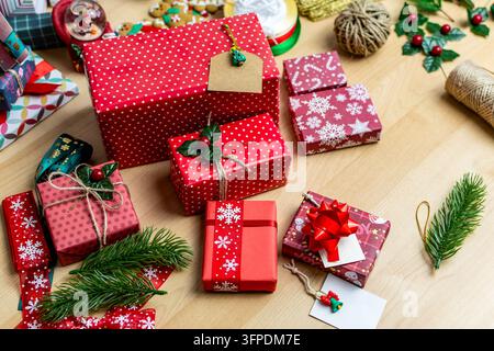 Arranging various christmas presents and holiday decorations on a wooden table Stock Photo