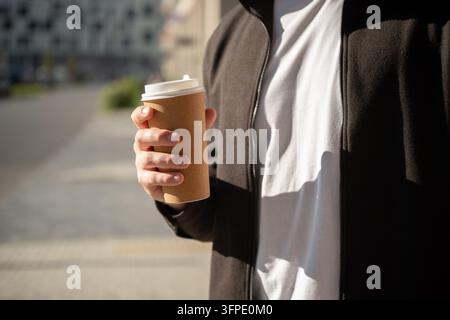 Man holding takeaway coffee outdoors Stock Photo