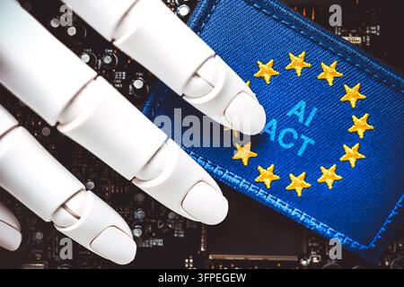 Robot hand on a computer circuit board and an EU flag with the words "AI Act, " photomontage Stock Photo