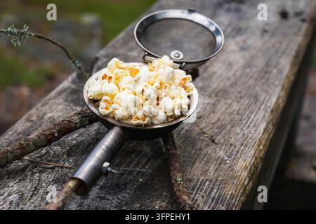 Popcorn made in a popcorn maker, fresh off the campfire. Stock Photo