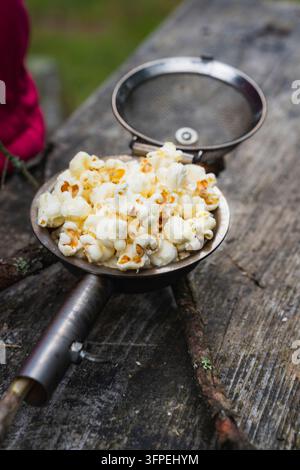 Popcorn made in a popcorn maker, fresh from the campfire. Stock Photo
