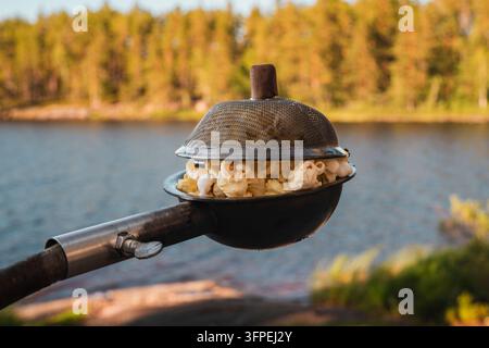 Popcorn made in a popcorn maker, fresh off the campfire. Stock Photo