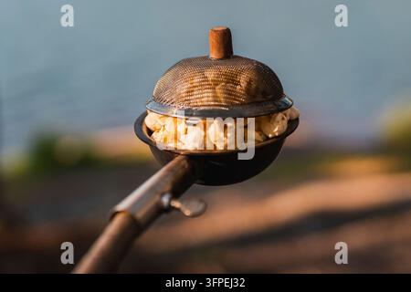 Popcorn made in a popcorn maker, fresh off the campfire. Stock Photo