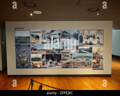 A collage of historical photos displayed on a wall in Hongseong, South Korea, showcasing local heritage and community life. Stock Photo