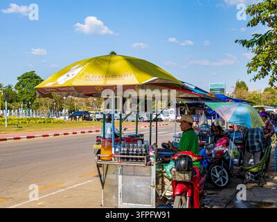 Street vendors operating roadside food and drink stalls near Patuxai (Victory Monument) in Vientiane, Laos. Stock Photo