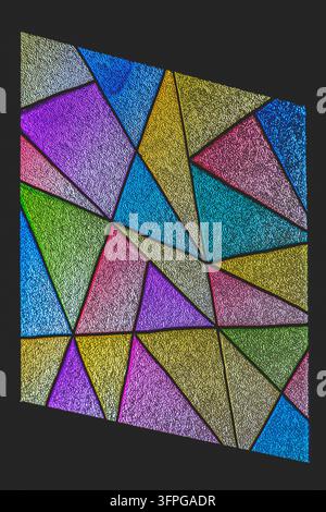 Intricate geometric stained glass window featuring vibrant multifaceted panels set against a dark background, evoking artistic harmony, structural des Stock Photo